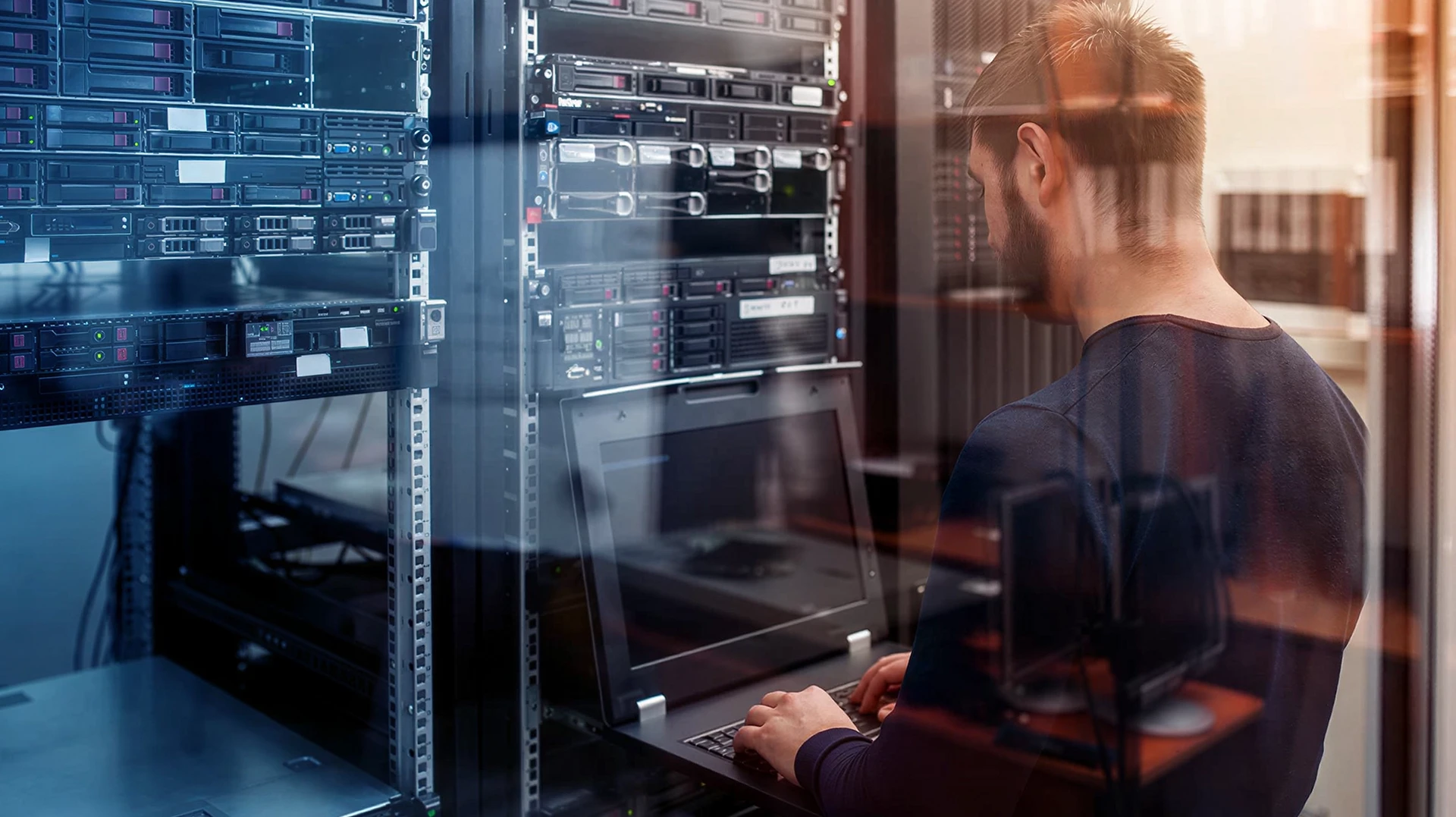 Ingénieur 2SRK au travail devant les baies de serveurs de son datacenter